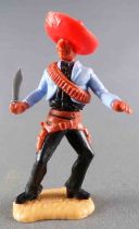 Timpo - Mexicans - Footed Holding Knife Blue Jacket Red Hat Black Legs With Right Foot Pointing  to the Right